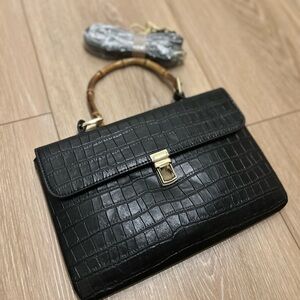 Black leather handbag with bamboo handle